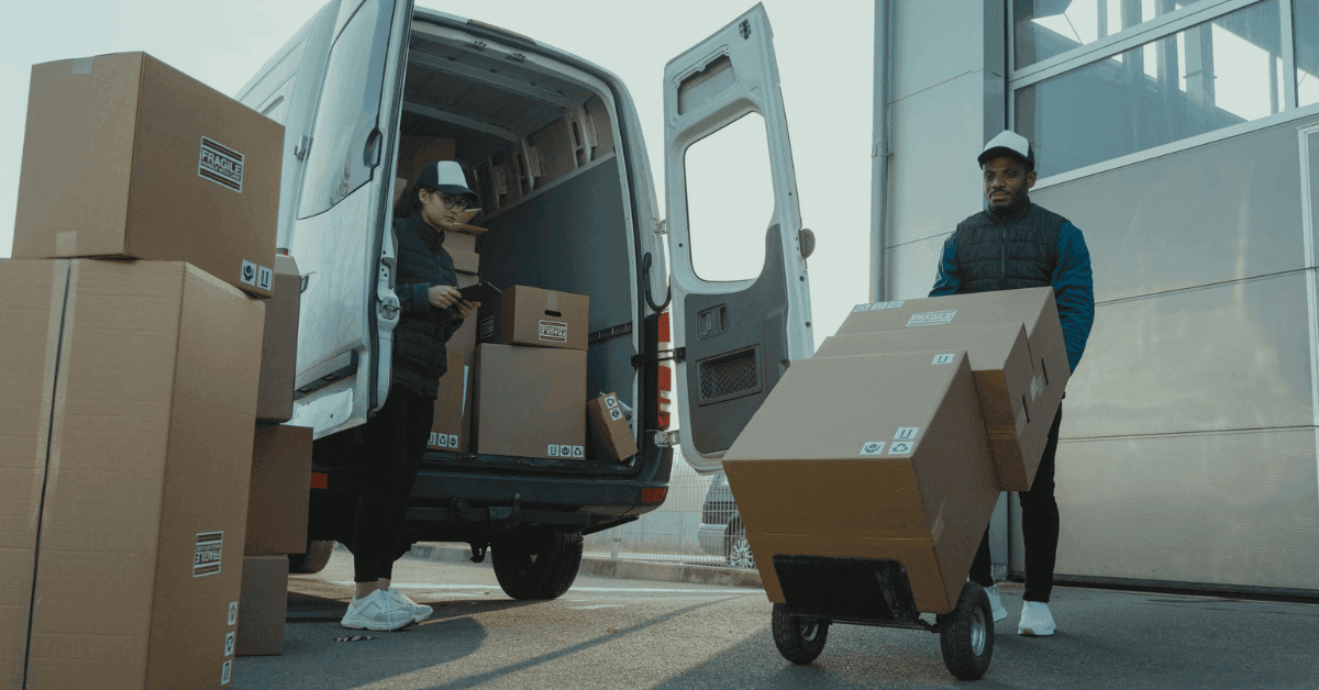 Workers loading a van at a warehouse dock