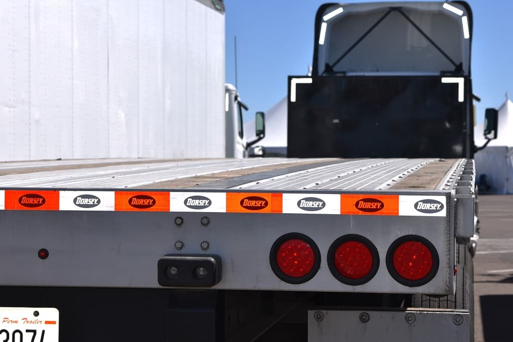 Yellow flatbed truck on a road